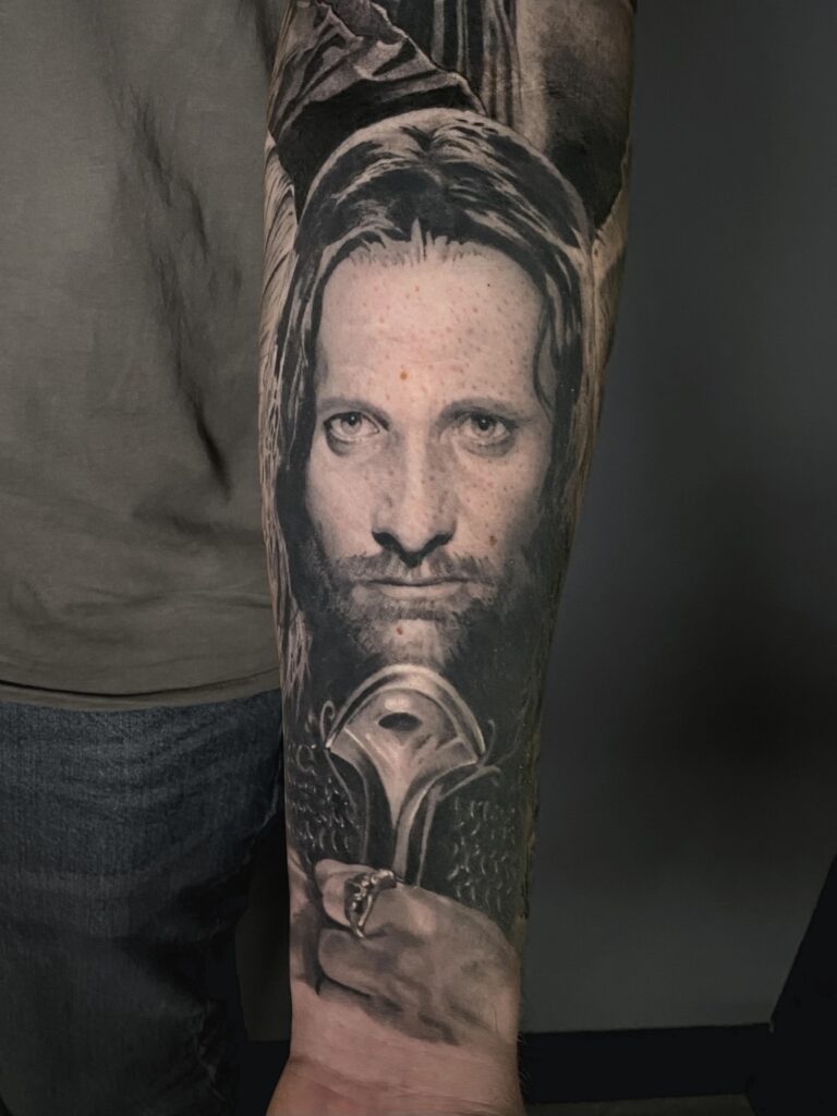 A black and grey lower arm tattoo of Aragorn, son of Arathorn.